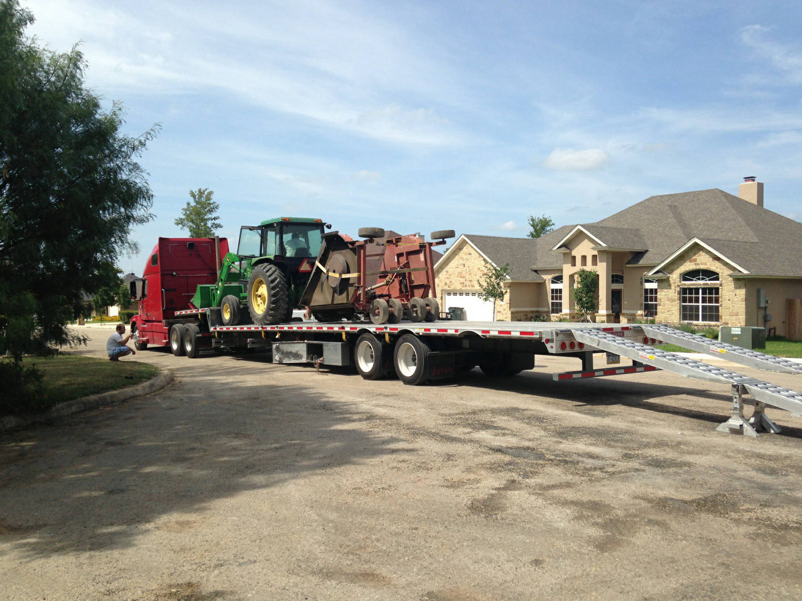 tractor with attachment and loading ramps